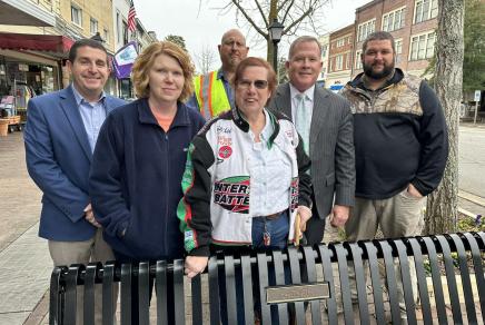 Town staff and Lisa Dees celebrate a memorial bench for Scott Dees