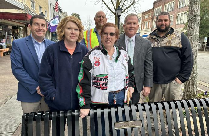 Town staff and Lisa Dees celebrate a memorial bench for Scott Dees